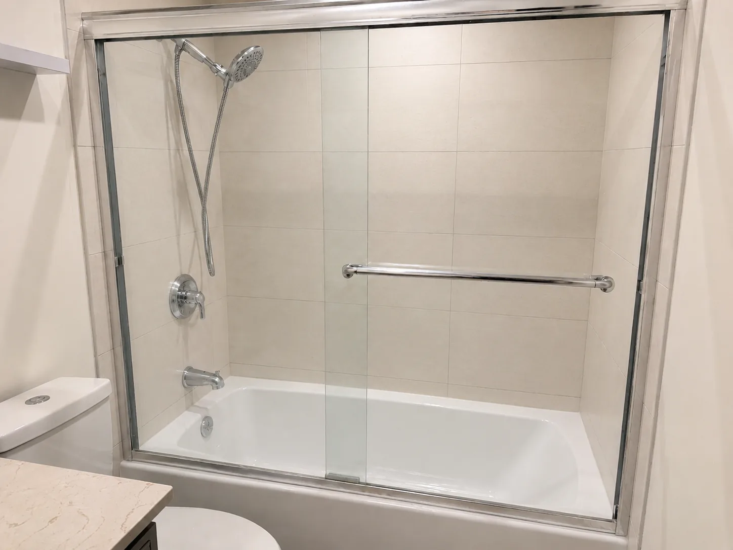 After: Clean bathtub shower glass after full shower refresh service in Vancouver