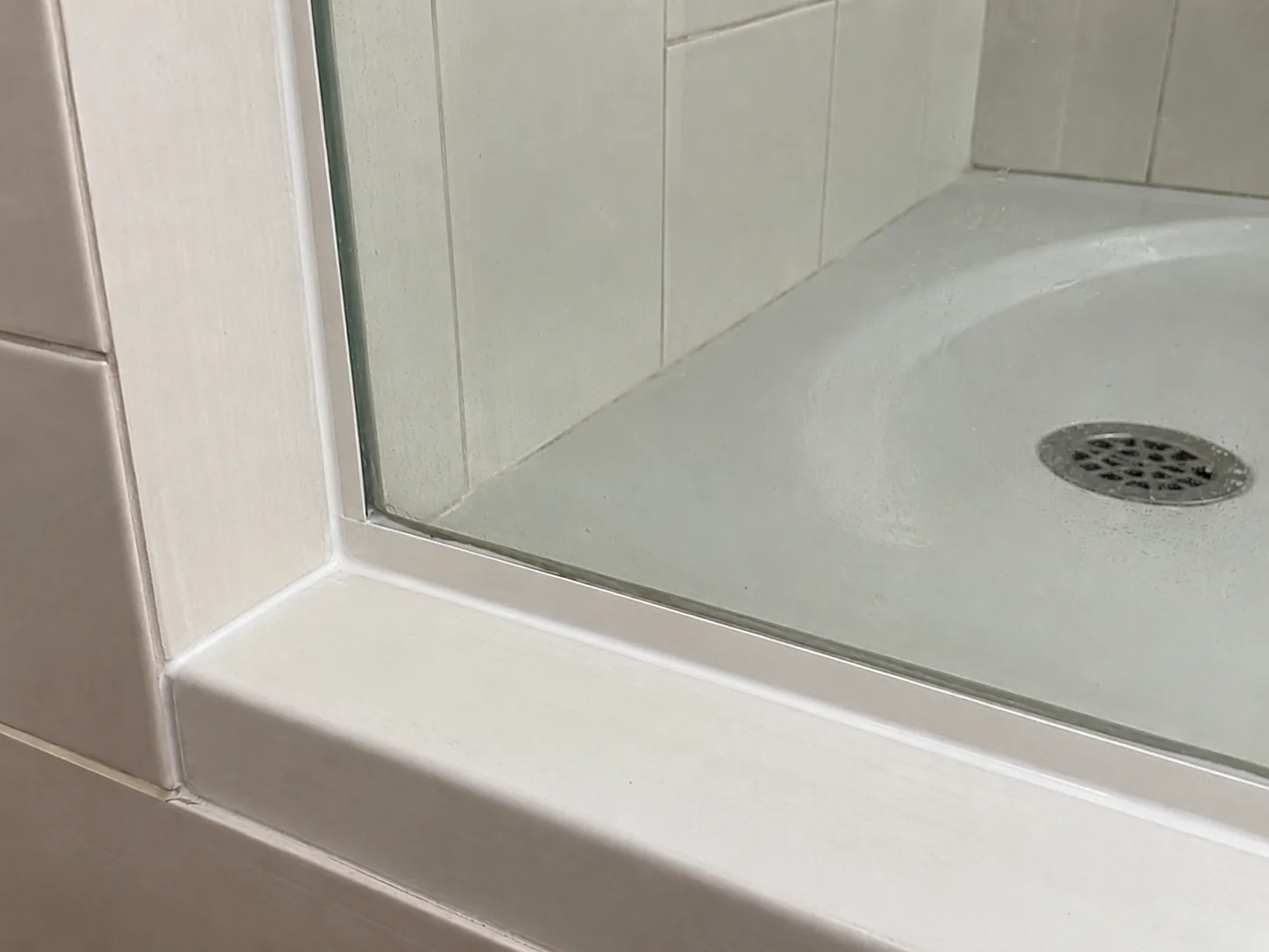 After: Fresh white shower silicone after shower recaulking service in Vancouver